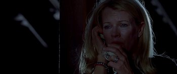 Movie still from “Cellular” (2004), directed by David R. Ellis – A woman is talking on a cell phone in the dark; Close Up shot, High angle