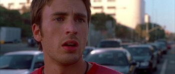 Movie still from “Cellular” (2004), directed by David R. Ellis – A man's face in a parking lot; Close Up shot, Low angle
