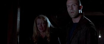 Movie still from “Cellular” (2004), directed by David R. Ellis – A man and a woman standing next to each other in the dark; Medium shot, Low angle