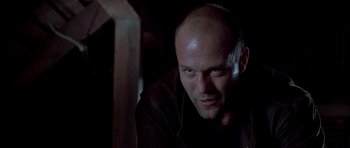 Movie still from “Cellular” (2004), directed by David R. Ellis – A man with a bald head looking at the camera; Close Up shot, Low angle