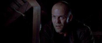Movie still from “Cellular” (2004), directed by David R. Ellis – A man with a bald head looking at the camera; Close Up shot, Low angle