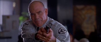Movie still from “Cellular” (2004), directed by David R. Ellis – A man holding a gun in his hand; Close Up shot, Low angle