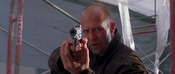 Movie still from “Cellular” (2004), directed by David R. Ellis – A man holding a gun in his hand; Close Up shot, Low angle