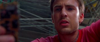 Movie still from “Cellular” (2004), directed by David R. Ellis – A man's face in front of a building; Close Up shot, Low angle