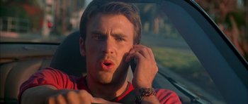 Movie still from “Cellular” (2004), directed by David R. Ellis – A man talking on a cell phone while sitting in a car; Close Up shot, Low angle