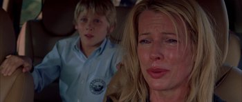 Movie still from “Cellular” (2004), directed by David R. Ellis – A woman and a boy crying in a room; Close Up shot, Over the shoulder angle