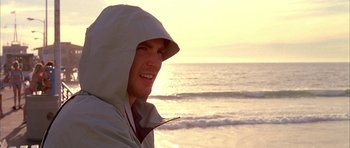 Movie still from “Cellular” (2004), directed by David R. Ellis – A man in a white jacket is standing on the beach; Close Up shot, Low angle