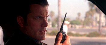 Movie still from “Cellular” (2004), directed by David R. Ellis – A person holding a walkie talkie; Close Up shot, Low angle