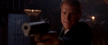 Movie still from “Cellular” (2004), directed by David R. Ellis – A person holding a gun in the dark; Close Up shot, Low angle