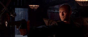 Movie still from “Cellular” (2004), directed by David R. Ellis – A man holding a video game controller in a dark room; Close Up shot, Low angle