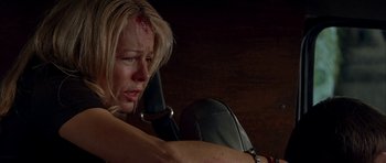 Movie still from “Cellular” (2004), directed by David R. Ellis – A woman with a bandage on her head is on a cell phone; Close Up shot, Low angle