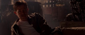 Movie still from “Cellular” (2004), directed by David R. Ellis – A man sitting on a couch in a dark room; Medium shot, Low angle