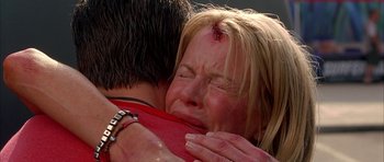 Movie still from “Cellular” (2004), directed by David R. Ellis – A woman is crying while hugging a man; Close Up shot, Low angle