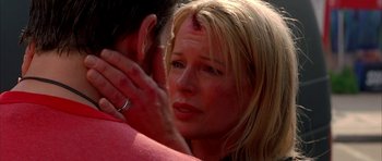 Movie still from “Cellular” (2004), directed by David R. Ellis – A woman is holding a man's face with a blood spot on her forehead; Close Up shot, Over the shoulder angle