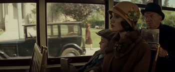 Movie still from “Changeling” (2008), directed by Clint Eastwood – A woman and a child sitting in front of an old car; Medium shot, Over the shoulder angle