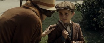 Movie still from “Changeling” (2008), directed by Clint Eastwood – A young boy wearing a bow tie talking to an older man; Close Up shot, Over the shoulder angle