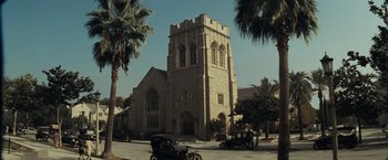 Movie still from “Changeling” (2008), directed by Clint Eastwood – An old car parked in front of an old church; Extreme Wide shot, Low angle