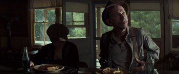 Movie still from “Changeling” (2008), directed by Clint Eastwood – A man and a woman sitting at a dinner table; Medium shot, Over the shoulder angle