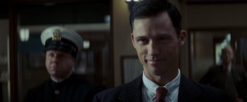 Movie still from “Changeling” (2008), directed by Clint Eastwood – A person wearing a suit and tie; Close Up shot, Over the shoulder angle