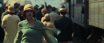 Movie still from “Changeling” (2008), directed by Clint Eastwood – A crowd of people walking down a street; Medium shot, Over the shoulder angle