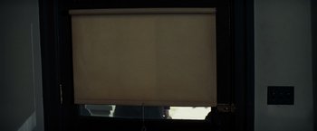 Movie still from “Changeling” (2008), directed by Clint Eastwood – A window with a roller blind in the middle of the room; Extreme Close Up shot, Low angle