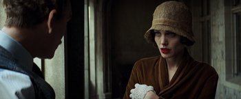 Movie still from “Changeling” (2008), directed by Clint Eastwood – A woman in a hat and a brown coat; Close Up shot, Over the shoulder angle