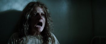Movie still from “Changeling” (2008), directed by Clint Eastwood – A woman with long white hair and an open mouth; Close Up shot, Low angle