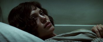 Movie still from “Changeling” (2008), directed by Clint Eastwood – A woman laying in a bed with her eyes closed; Close Up shot, Overhead angle