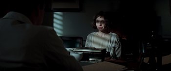 Movie still from “Changeling” (2008), directed by Clint Eastwood – A woman sitting in front of an old fashioned typewriter; Medium shot, Over the shoulder angle