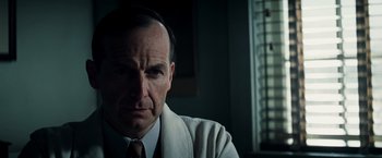 Movie still from “Changeling” (2008), directed by Clint Eastwood – A person wearing a suit and tie; Close Up shot, Low angle