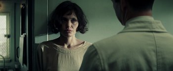 Movie still from “Changeling” (2008), directed by Clint Eastwood – A woman standing in front of a man in front of a mirror; Close Up shot, Over the shoulder angle