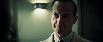 Movie still from “Changeling” (2008), directed by Clint Eastwood – A person wearing a suit and tie; Close Up shot, Low angle