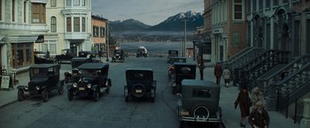 Movie still from “Changeling” (2008), directed by Clint Eastwood – An image of an old time car show in a city setting; Extreme Wide shot, High angle