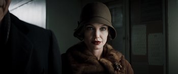 Movie still from “Changeling” (2008), directed by Clint Eastwood – A woman wearing a brown hat and a fur coat; Close Up shot, Low angle