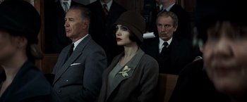 Movie still from “Changeling” (2008), directed by Clint Eastwood – A group of people sitting in a room; Medium shot, High angle