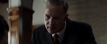 Movie still from “Changeling” (2008), directed by Clint Eastwood – An older man wearing a suit and tie; Close Up shot, Low angle