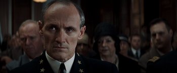 Movie still from “Changeling” (2008), directed by Clint Eastwood – A man in a military uniform looking at the camera; Close Up shot, Over the shoulder angle