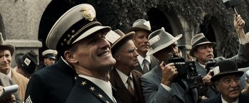 Movie still from “Changeling” (2008), directed by Clint Eastwood – A group of men wearing hats and smiling for a picture; Close Up shot, Low angle