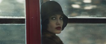 Movie still from “Changeling” (2008), directed by Clint Eastwood – A woman in a hat looking out of a window; Close Up shot, Low angle