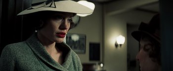 Movie still from “Changeling” (2008), directed by Clint Eastwood – A woman wearing a white hat in a dark room; Close Up shot, Low angle