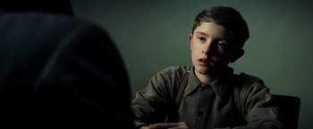 Movie still from “Changeling” (2008), directed by Clint Eastwood – A young man sitting in front of a mirror in a room; Close Up shot, Over the shoulder angle