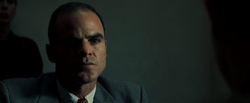 Movie still from “Changeling” (2008), directed by Clint Eastwood – A person wearing a suit and tie; Close Up shot, Low angle