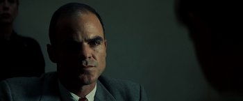 Movie still from “Changeling” (2008), directed by Clint Eastwood – A person wearing a suit and tie; Close Up shot, Low angle