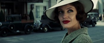 Movie still from “Changeling” (2008), directed by Clint Eastwood – A woman wearing a white hat and red lipstick; Close Up shot, Over the shoulder angle