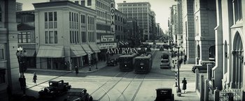 Movie still from “Changeling” (2008), directed by Clint Eastwood – A black and white photo of a city street; Extreme Wide shot, High angle