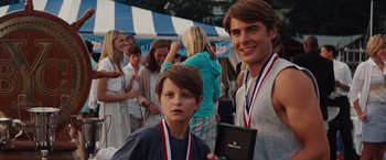 Movie still from “Charlie St. Cloud” (2010), directed by Burr Steers – Two young men standing next to each other holding medals; Medium shot, Over the shoulder angle