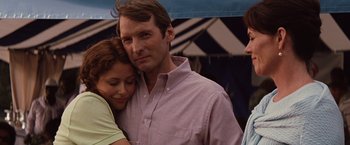 Movie still from “Charlie St. Cloud” (2010), directed by Burr Steers – A man and a woman are hugging under an awning; Close Up shot, Over the shoulder angle
