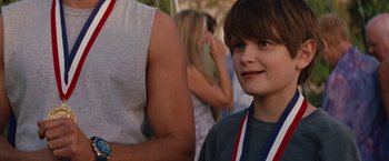 Movie still from “Charlie St. Cloud” (2010), directed by Burr Steers – A young boy with a medal around his neck; Close Up shot, Over the shoulder angle