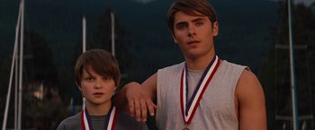 Movie still from “Charlie St. Cloud” (2010), directed by Burr Steers – Two young men standing next to each other with medals around their necks; Medium shot, Low angle