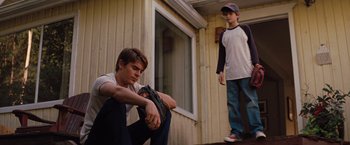 Movie still from “Charlie St. Cloud” (2010), directed by Burr Steers – Two young men sitting on the porch of a house; Medium shot, Low angle